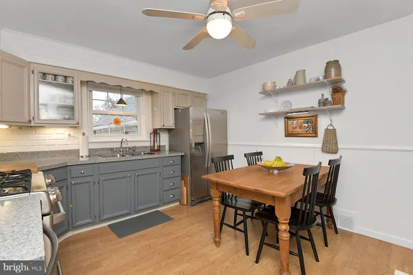 a kitchen with a table chairs stove and refrigerator