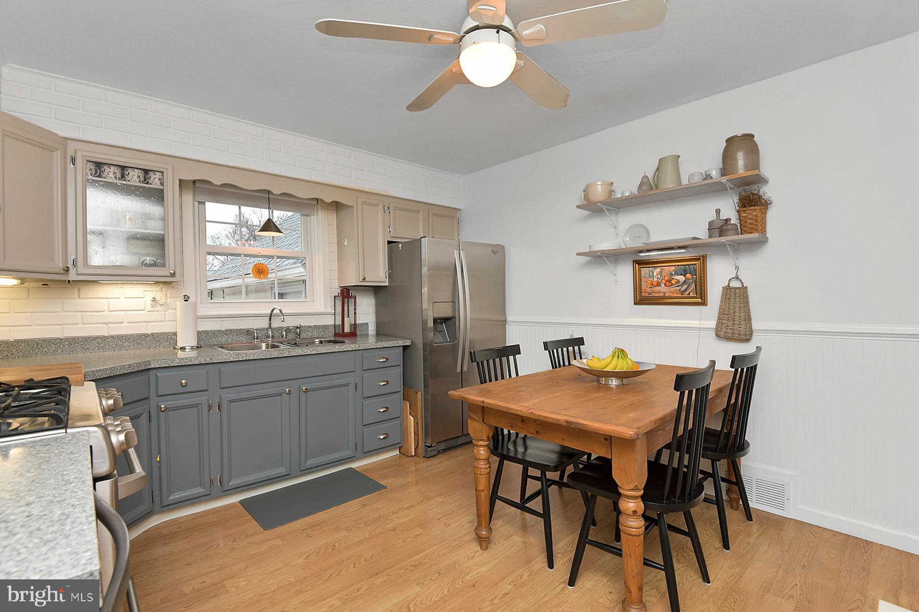 56 Ridgewood Avenue Ewing, NJ 08618 - Photo 10 of 28 a kitchen with a table chairs stove and refrigerator