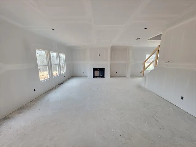 a view of a livingroom with a fireplace and window