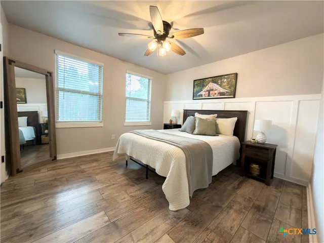 a bedroom with a bed and a chandelier