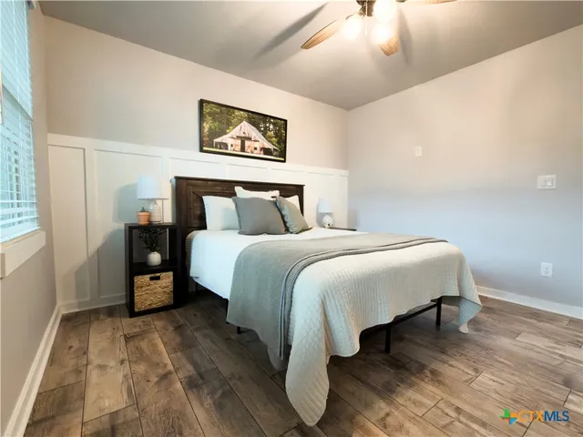 a bed room with a bed and a painting