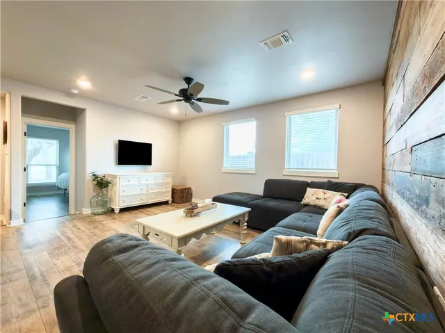 a living room with furniture and flat screen tv