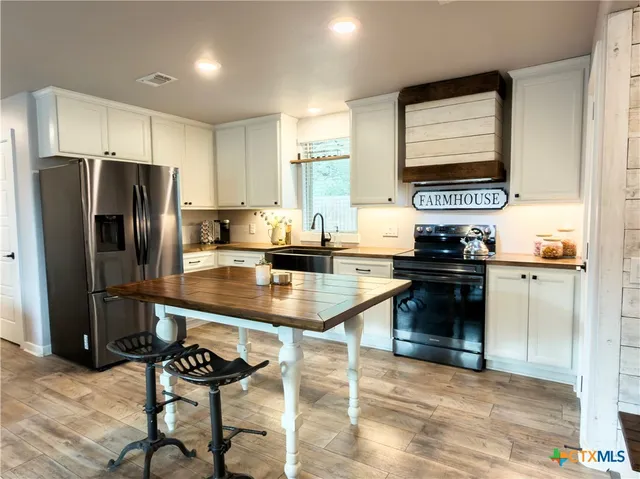 a kitchen with a refrigerator and a sink