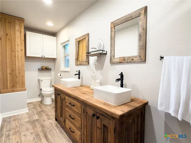 a spacious bathroom with a sink double vanity and a mirror