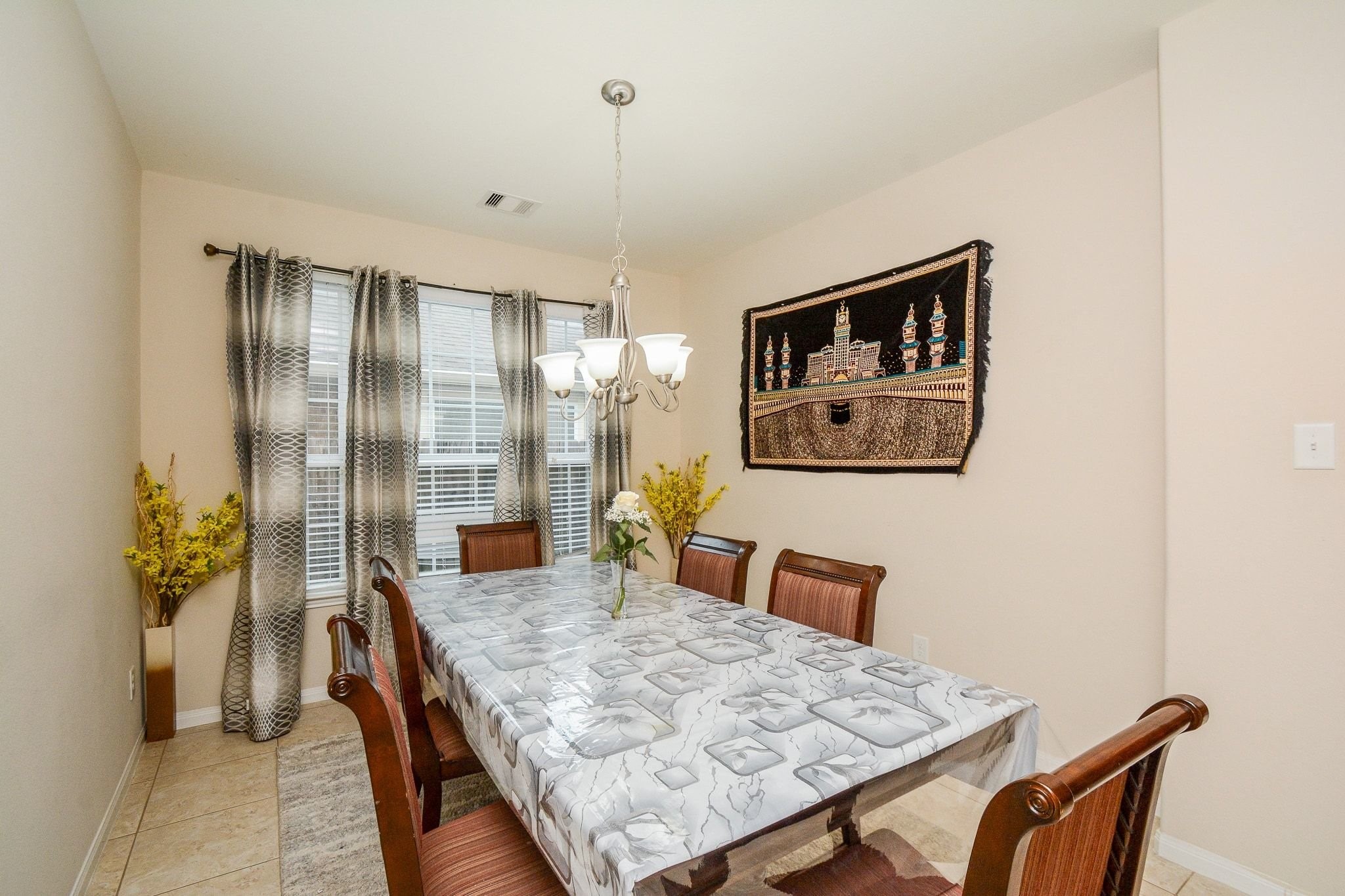 7046 Sliding Rock Circle Spring, TX 77379 - Photo 7 of 41 Elegant dining room with ample natural light, featuring a stylish chandelier and space for family gatherings.