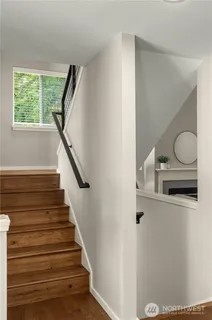a view of entryway and hall with wooden floor