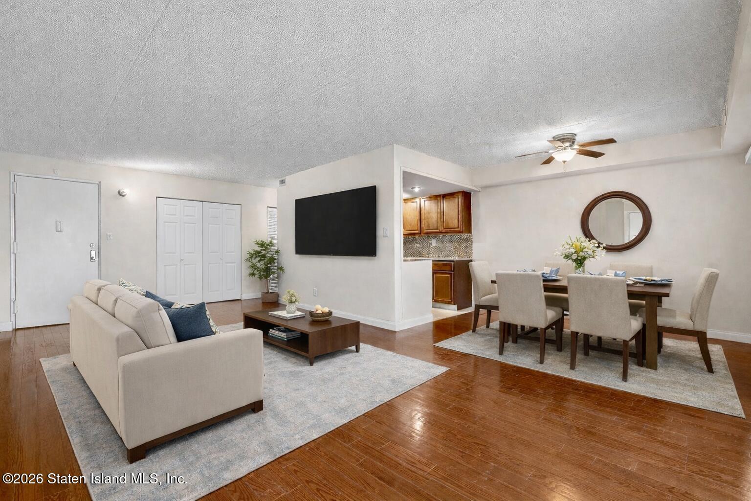11 Windham Loop, Unit 5LL Staten Island, NY 10314 - Photo 6 of 19 a living room with furniture and a flat screen tv