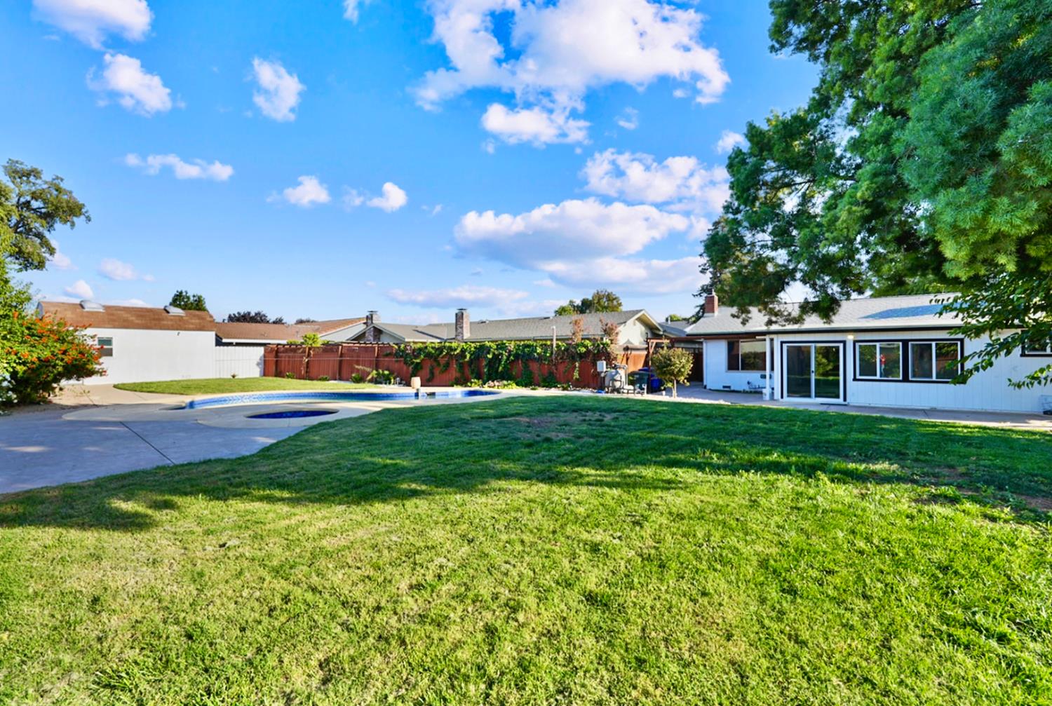 728 R Street Newman, CA 95360 - Photo 13 of 19 a front view of a house with a garden