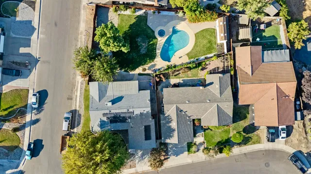 an aerial view of a houses with street
