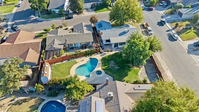 an aerial view of a house with yard swimming pool and outdoor seating