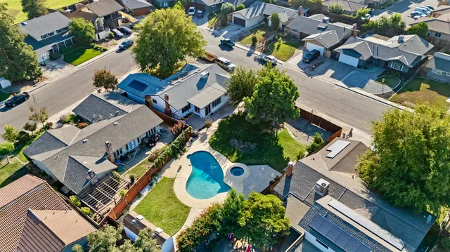 an aerial view of a house with garden space and street view