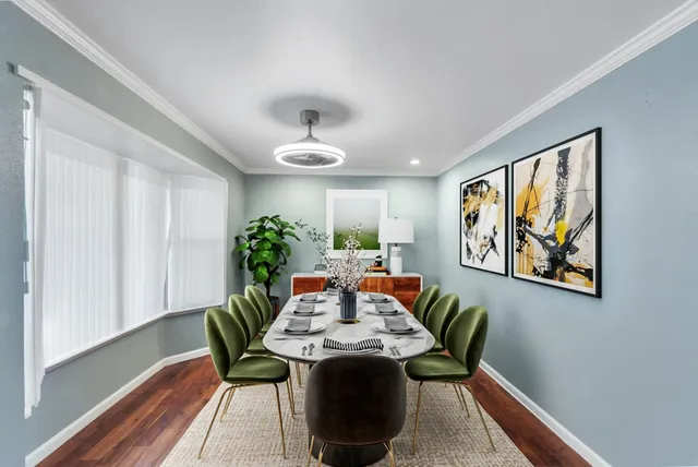 a view of a dining room with furniture window and wooden floor
