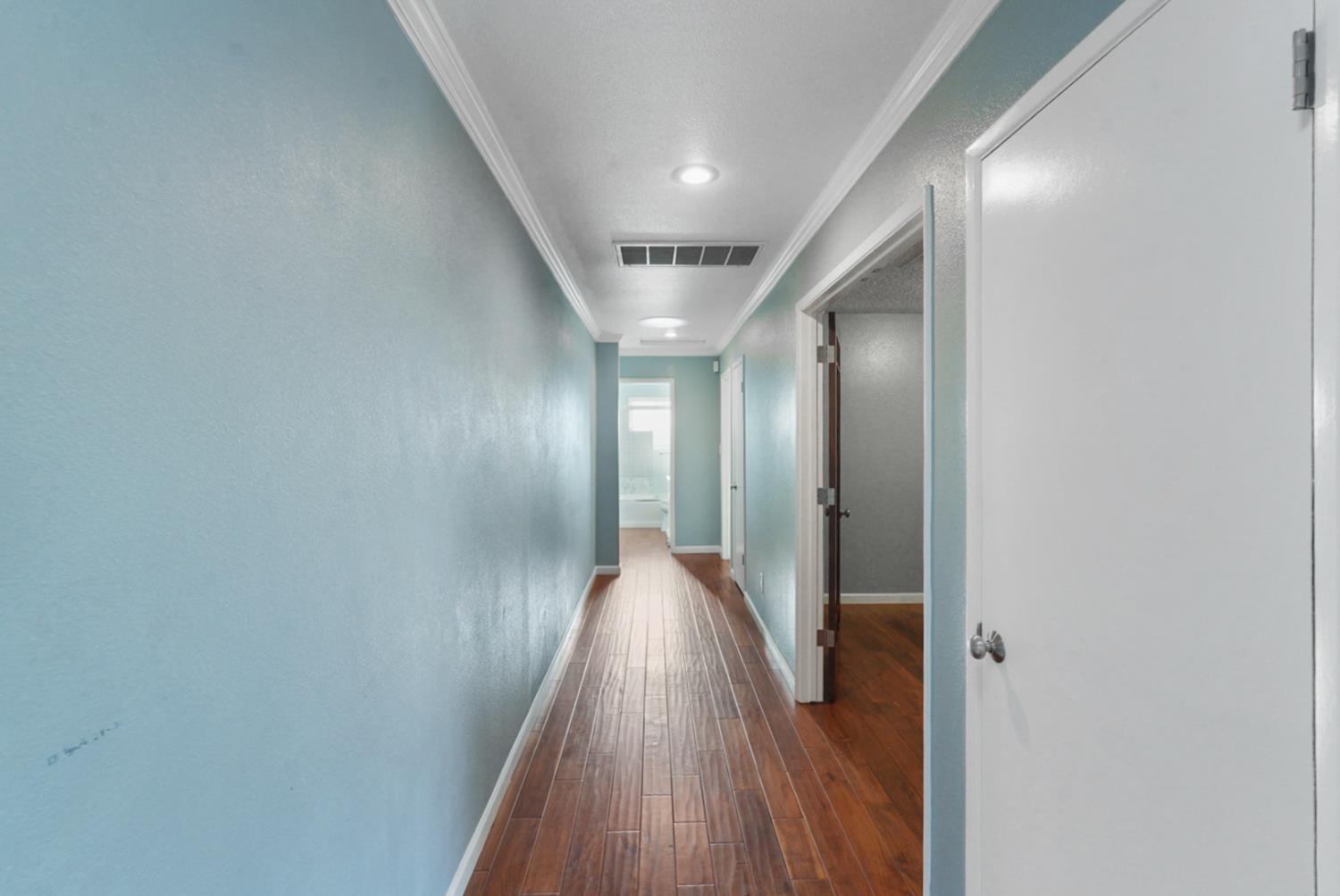 728 R Street Newman, CA 95360 - Photo 7 of 19 a view of hallway with wooden floor