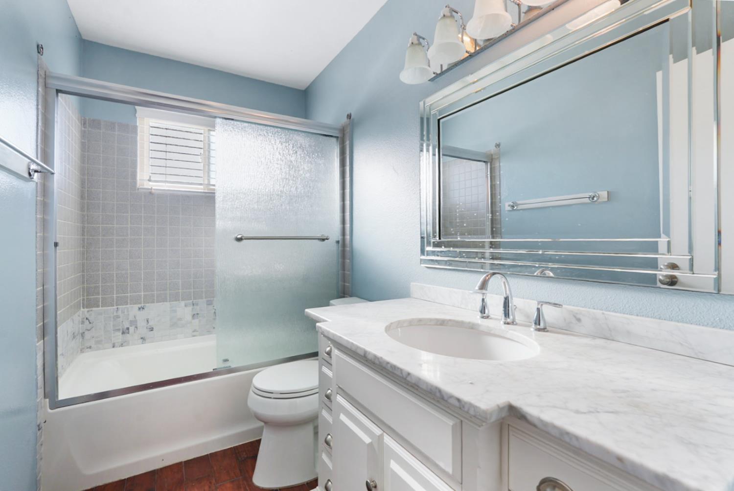 728 R Street Newman, CA 95360 - Photo 8 of 19 a bathroom with a granite countertop sink toilet and shower