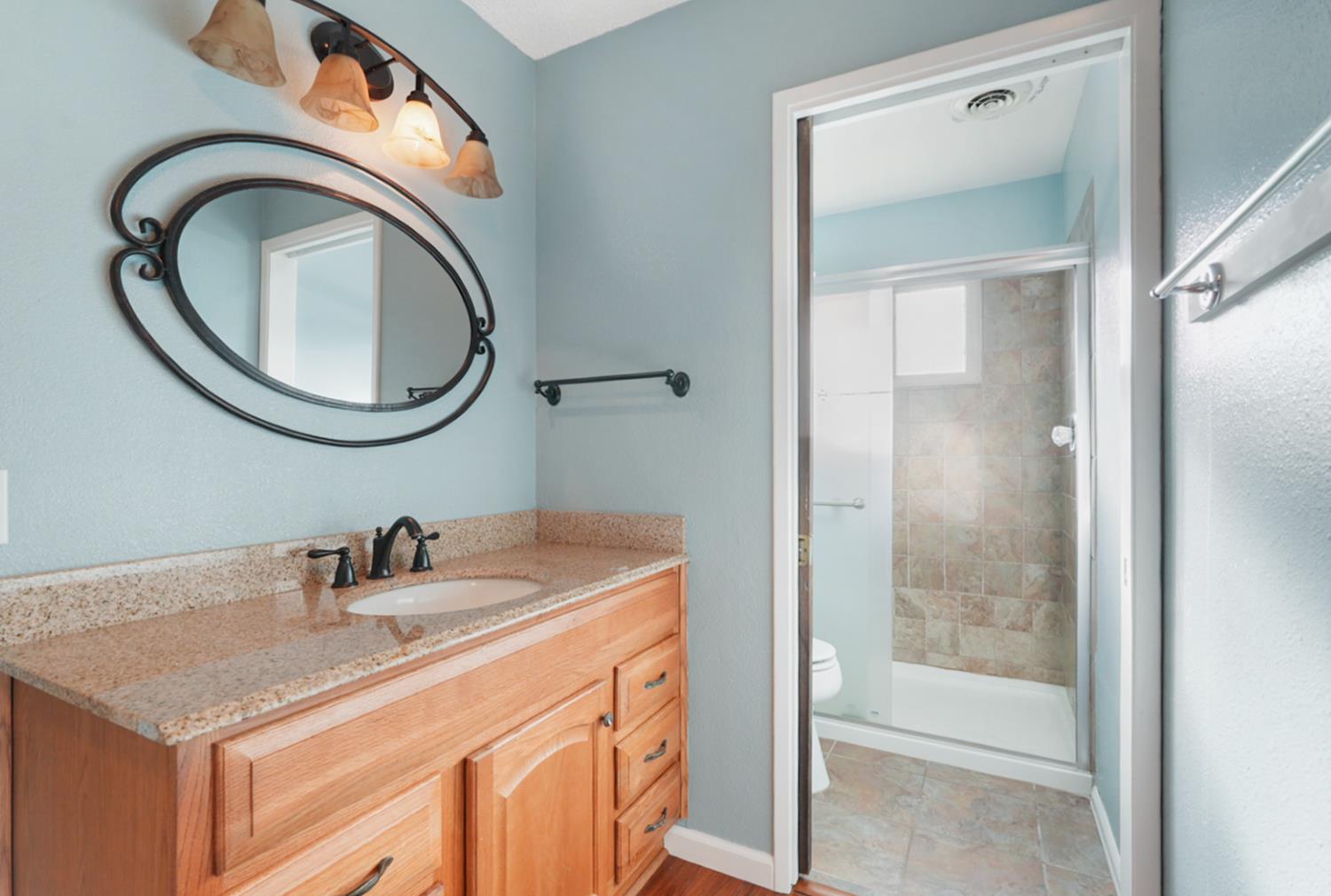 728 R Street Newman, CA 95360 - Photo 10 of 19 a bathroom with a sink a toilet and a mirror