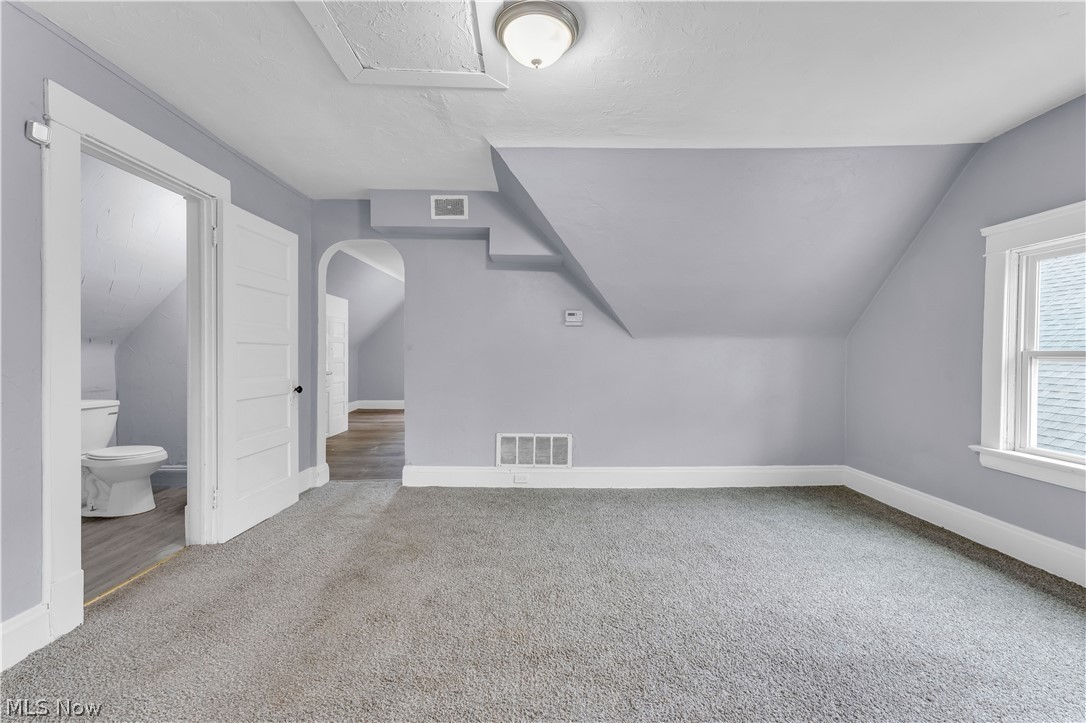 13609 Blenheim Road Cleveland, OH 44110 - Photo 8 of 20 Additional living space with vaulted ceiling and carpet flooring