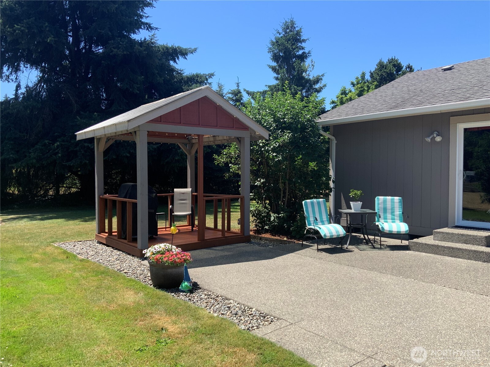 20110 Rainey Lane Southwest Rochester, WA 98579 - Photo 14 of 40 a view of a house with a patio