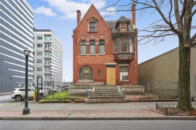 front view of a brick house with a street