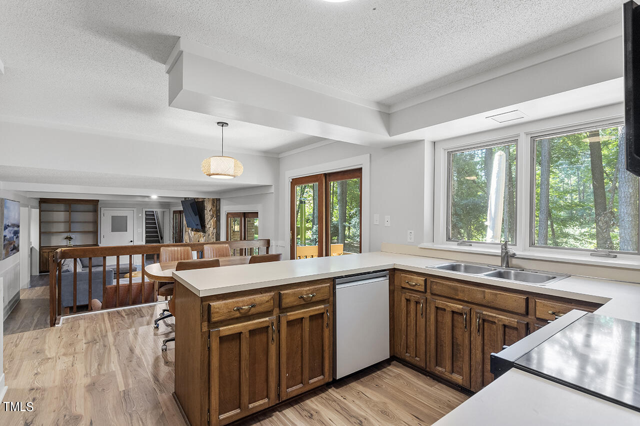 705 Lanham Place Raleigh, NC 27615 - Photo 13 of 53 a kitchen with a stove a sink a dining table and chairs