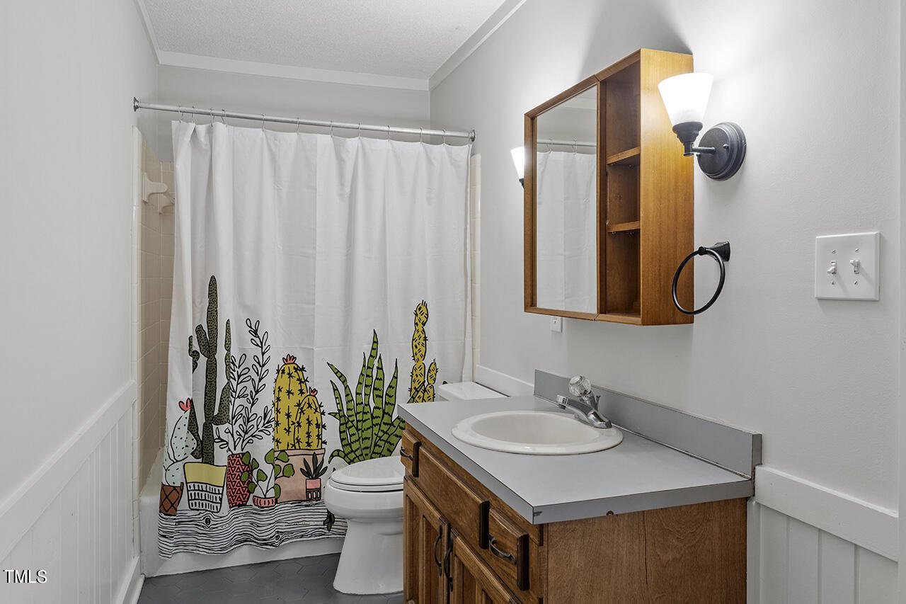 705 Lanham Place Raleigh, NC 27615 - Photo 24 of 53 a bathroom with a granite countertop sink and a mirror