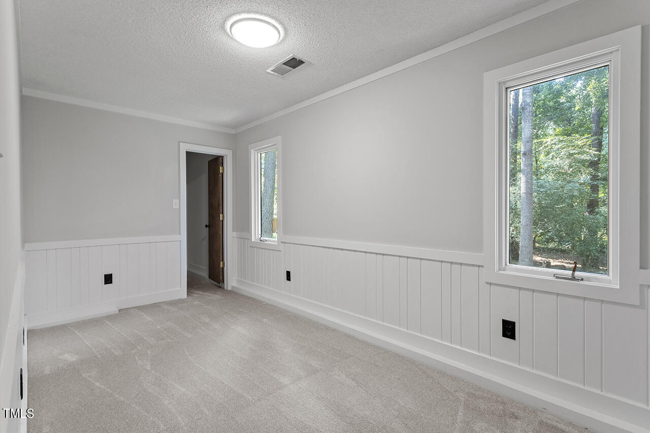 705 Lanham Place Raleigh, NC 27615 - Photo 27 of 53 a view of an empty room with a window