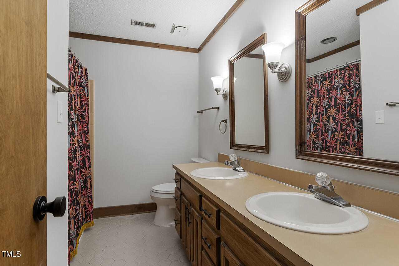 705 Lanham Place Raleigh, NC 27615 - Photo 34 of 53 a bathroom with a sink and a mirror
