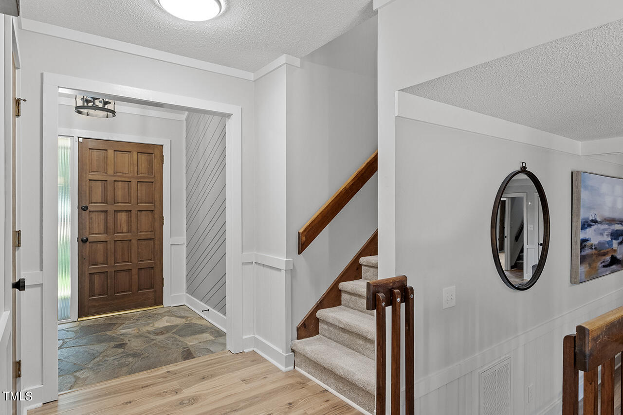 705 Lanham Place Raleigh, NC 27615 - Photo 4 of 53 a view of a hallway with wooden floor and entryway