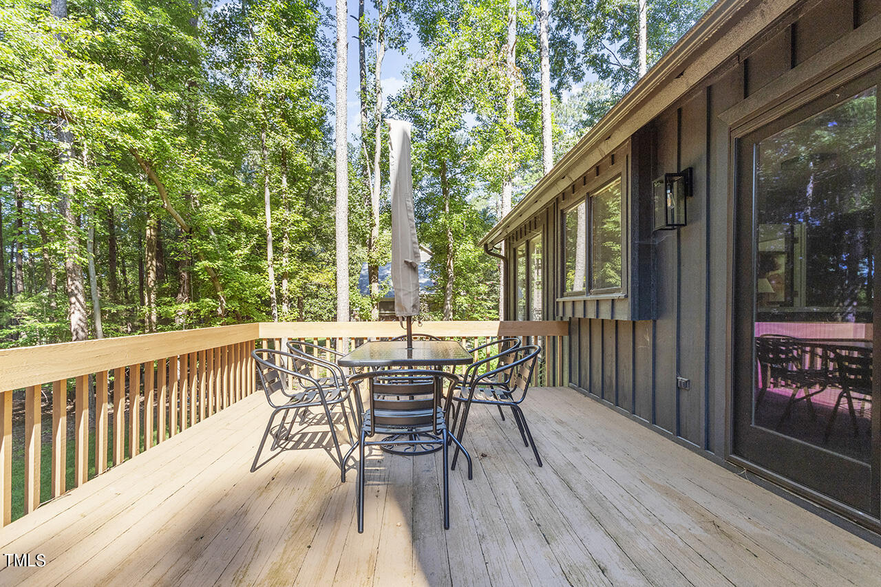 705 Lanham Place Raleigh, NC 27615 - Photo 41 of 53 a view of a deck with table and chairs and wooden floor