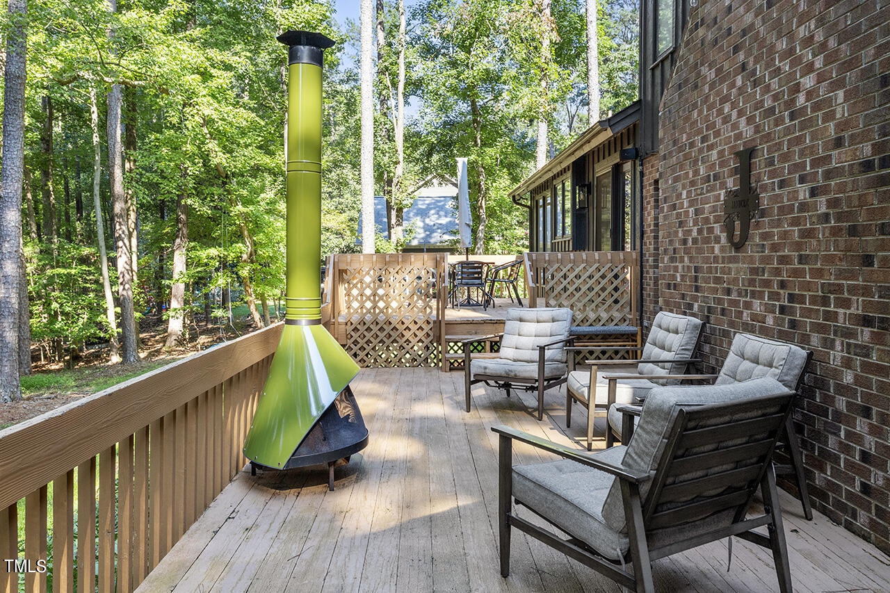 705 Lanham Place Raleigh, NC 27615 - Photo 43 of 53 a view of a deck with couches table and chairs with wooden floor and fence