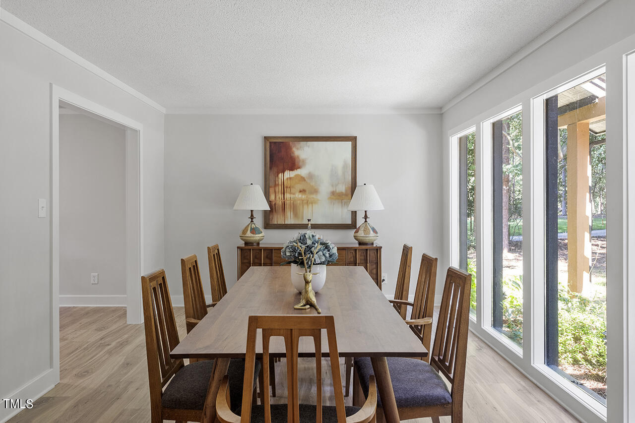 705 Lanham Place Raleigh, NC 27615 - Photo 6 of 53 a view of a dining room with furniture window and wooden floor