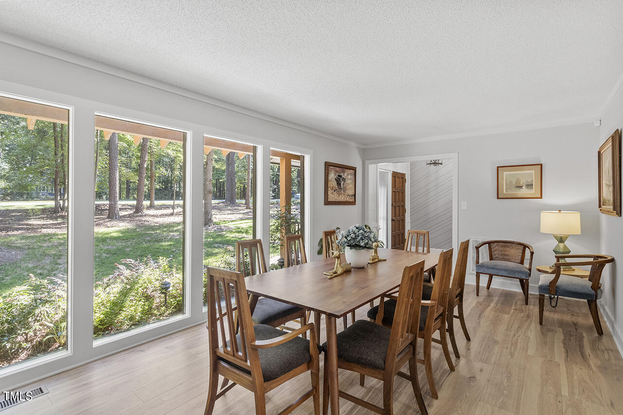 705 Lanham Place Raleigh, NC 27615 - Photo 7 of 53 a view of a dining room with furniture and wooden floor