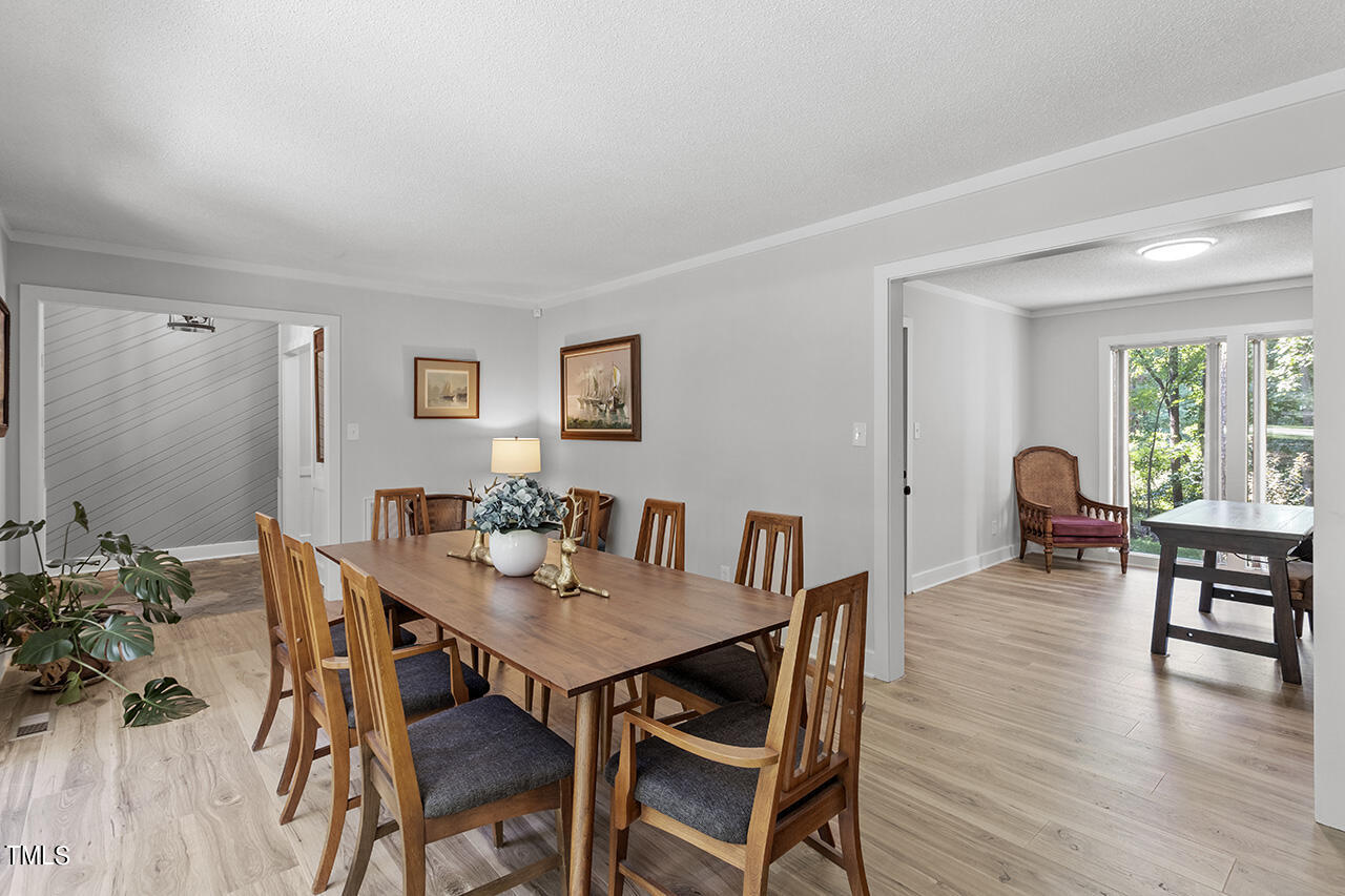 705 Lanham Place Raleigh, NC 27615 - Photo 8 of 53 a view of a dining room with furniture and wooden floor