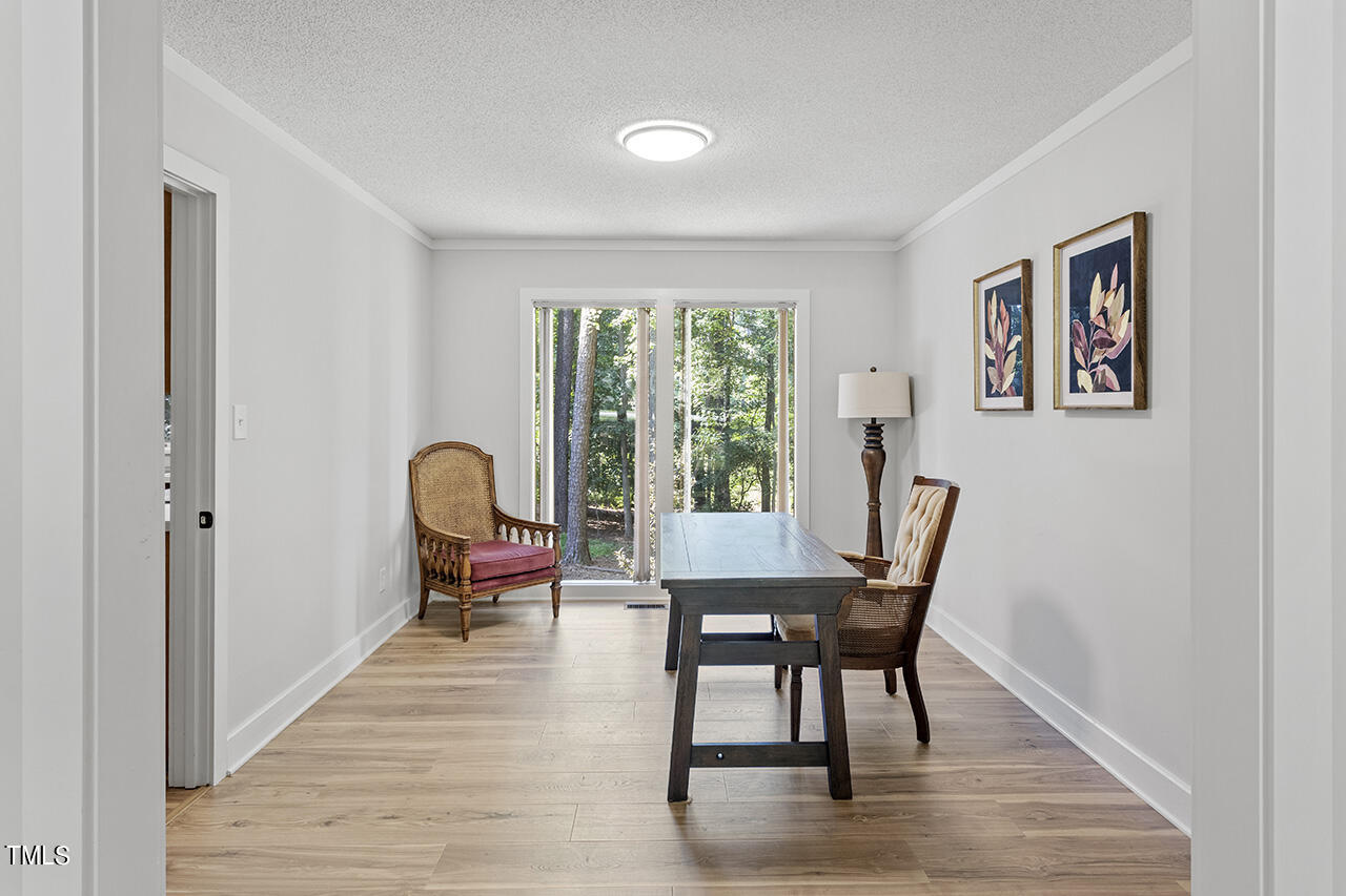 705 Lanham Place Raleigh, NC 27615 - Photo 9 of 53 a dining room with furniture and wooden floor