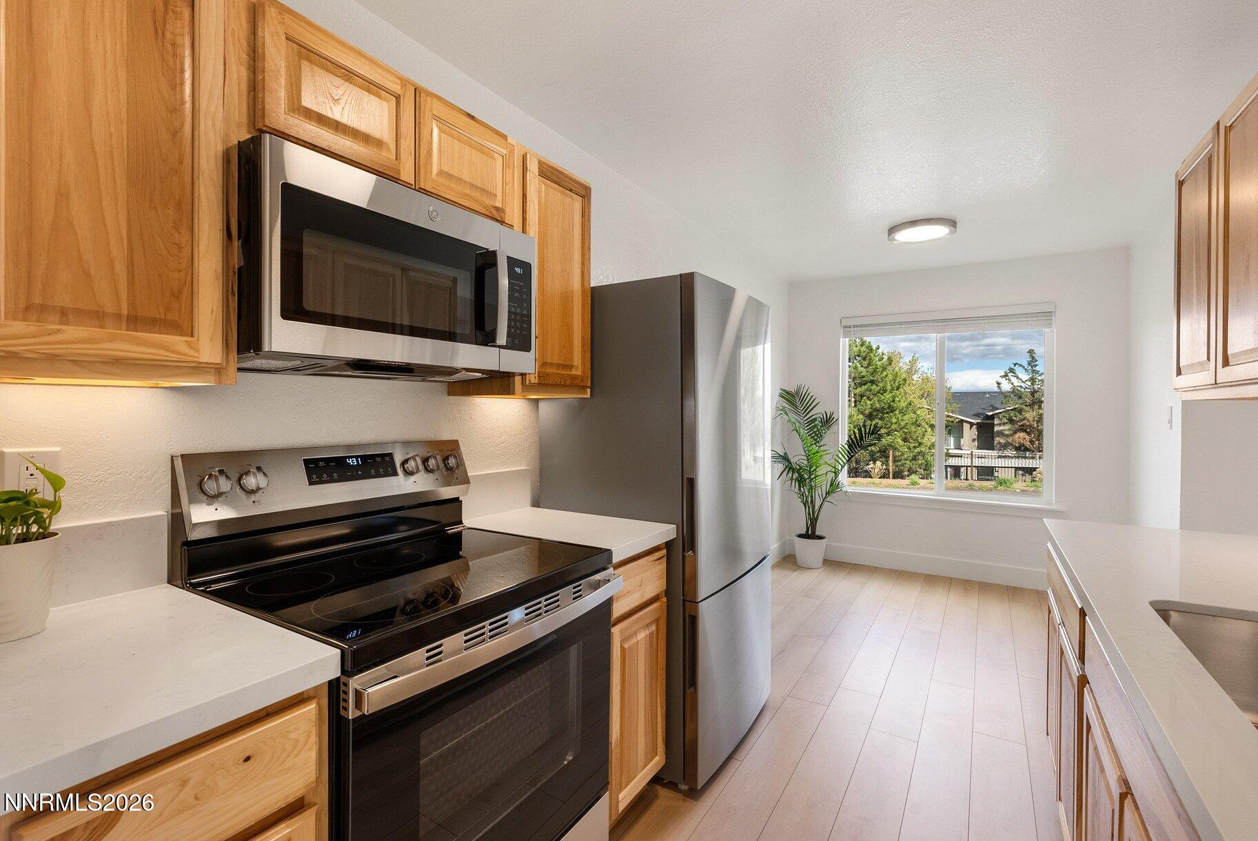 3935 Clear Acre Lane, Unit 211 Reno, NV 89512 - Photo 2 of 25 a kitchen with a stove microwave and refrigerator