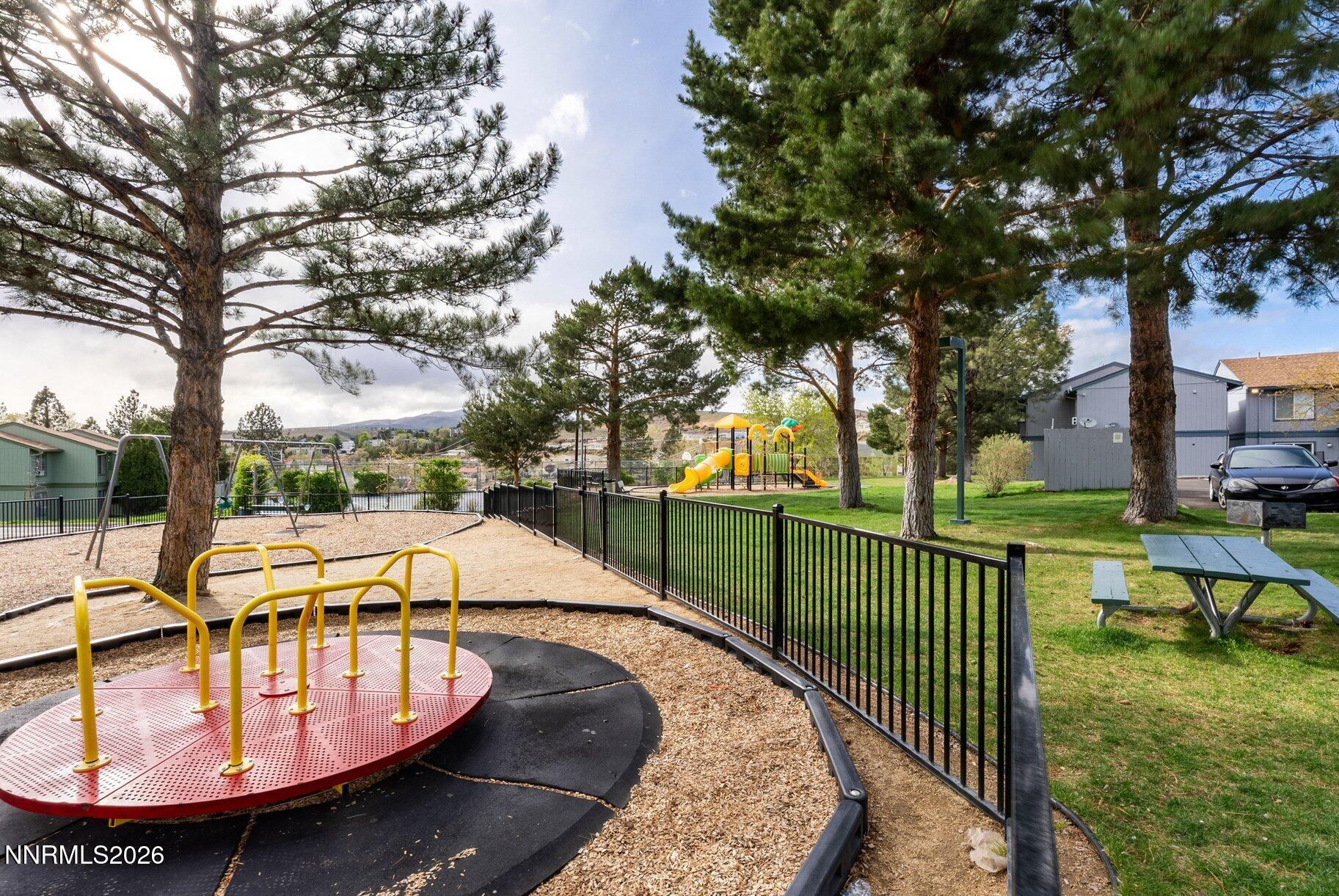 3935 Clear Acre Lane, Unit 211 Reno, NV 89512 - Photo 22 of 25 a view of a swimming pool with a patio and a yard