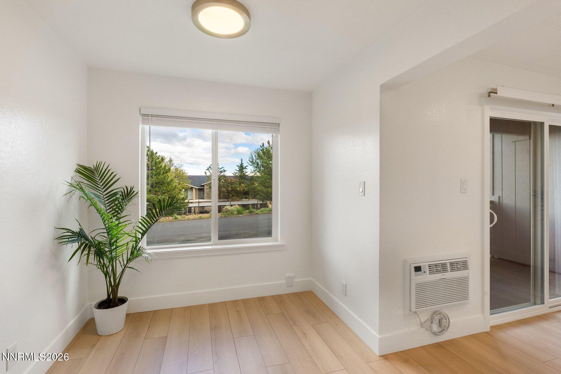 3935 Clear Acre Lane, Unit 211 Reno, NV 89512 - Photo 5 of 25 a view of empty room with window and wooden floor