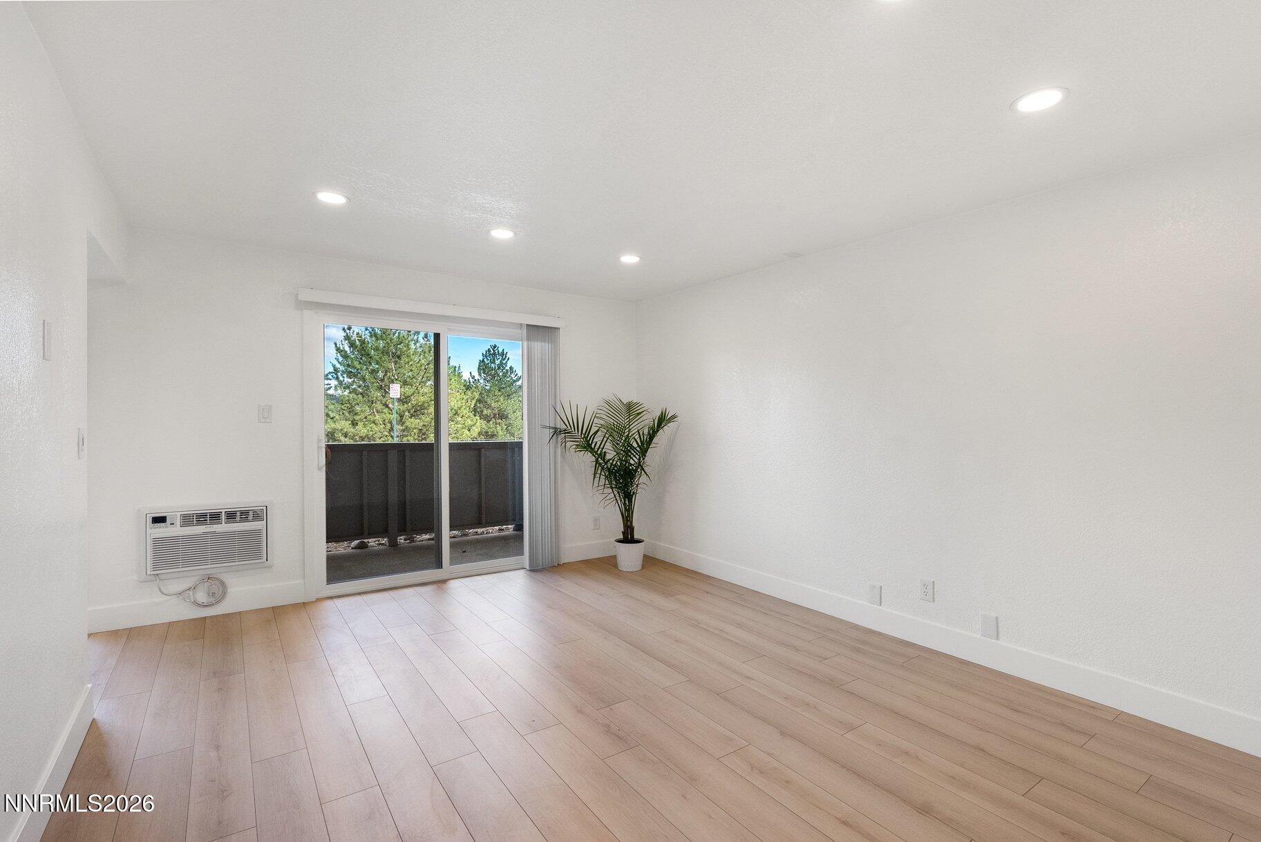 3935 Clear Acre Lane, Unit 211 Reno, NV 89512 - Photo 6 of 25 a view of a room with wooden floor and a window