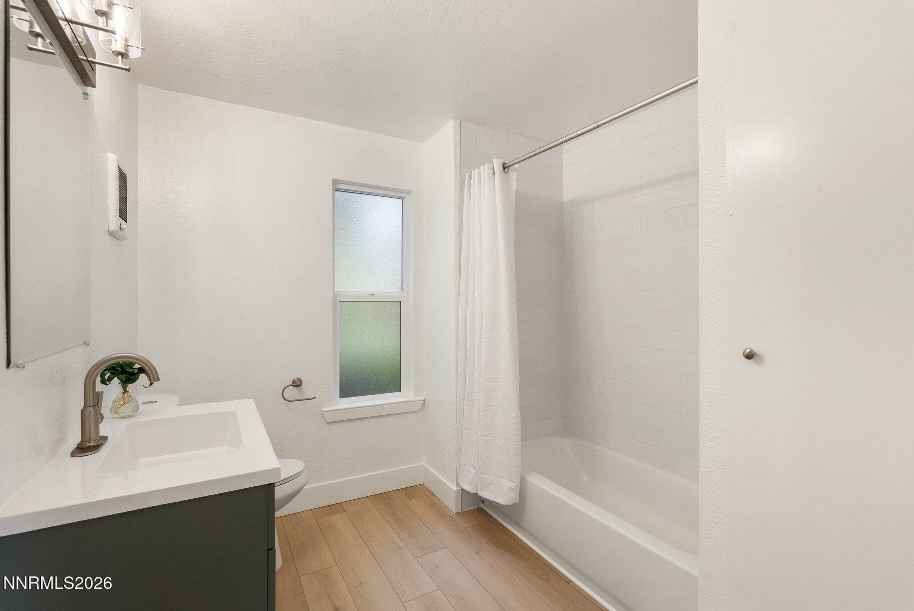 3935 Clear Acre Lane, Unit 211 Reno, NV 89512 - Photo 8 of 25 a bathroom with a bathtub a sink and a mirror