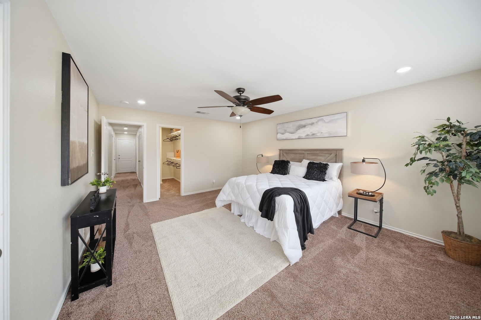 5607 Spring Quail San Antonio, TX 78247 - Photo 11 of 25 a bedroom with a bed and a potted plant on the dresser