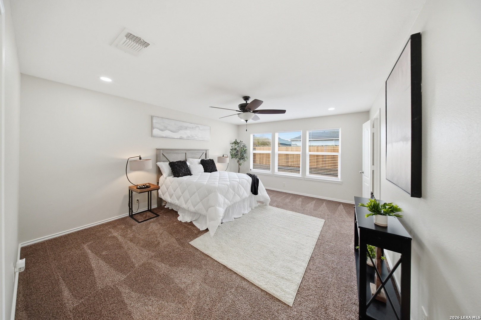 5607 Spring Quail San Antonio, TX 78247 - Photo 12 of 25 a bed room with a bed window and potted plant on table