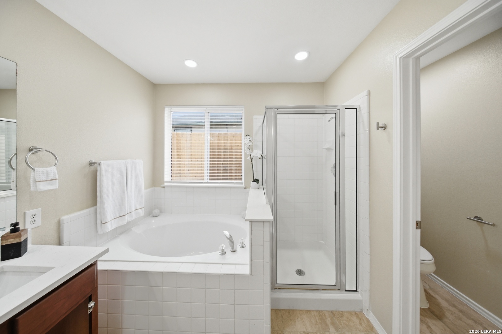 5607 Spring Quail San Antonio, TX 78247 - Photo 14 of 25 a bathroom with a bathtub and a sink