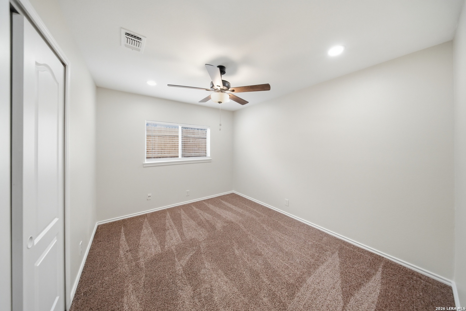 5607 Spring Quail San Antonio, TX 78247 - Photo 18 of 25 a view of an empty room with a ceiling fan