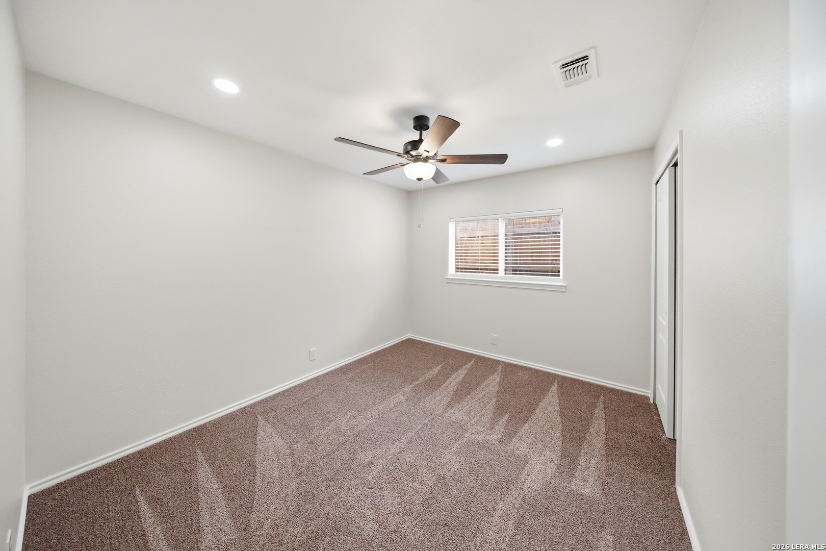 5607 Spring Quail San Antonio, TX 78247 - Photo 21 of 25 a view of an empty room with a ceiling fan