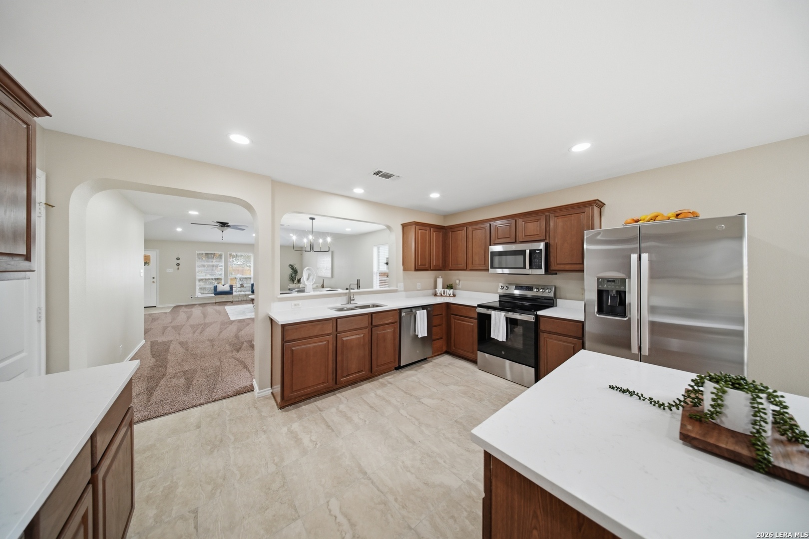 5607 Spring Quail San Antonio, TX 78247 - Photo 7 of 25 a large kitchen with kitchen island a sink table and chairs