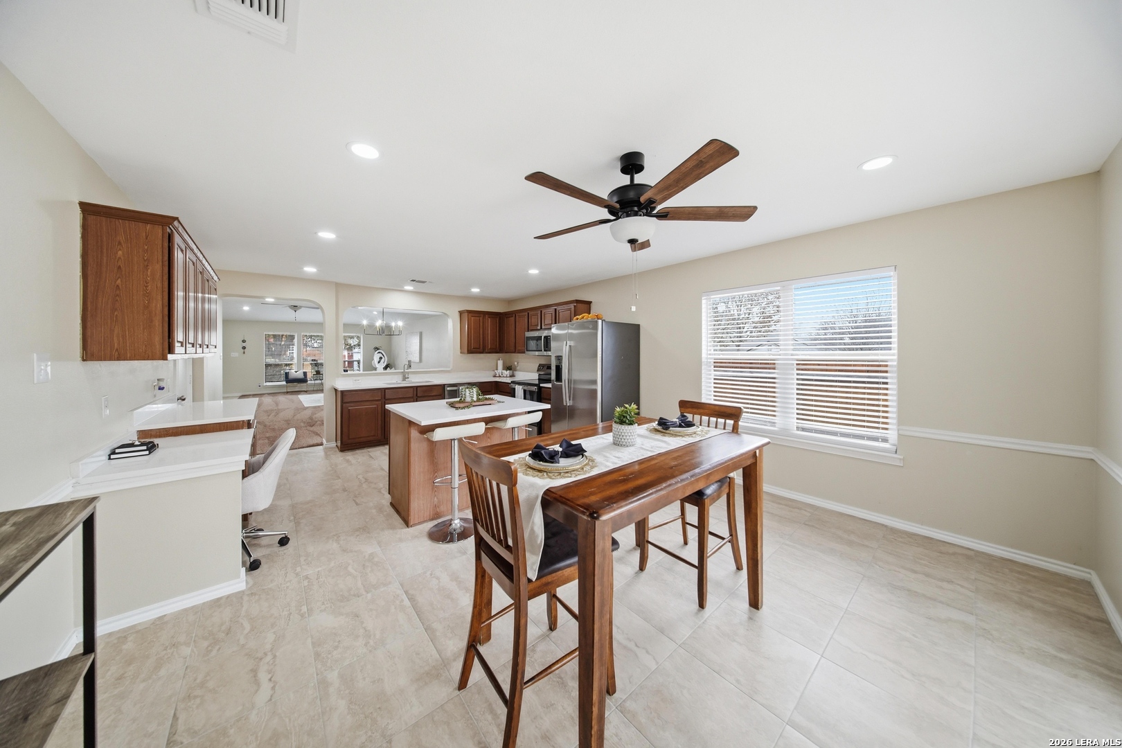 5607 Spring Quail San Antonio, TX 78247 - Photo 10 of 25 a room with stainless steel appliances kitchen island a table and chairs in it