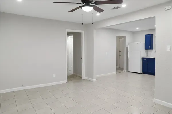 an empty room with closet and fan