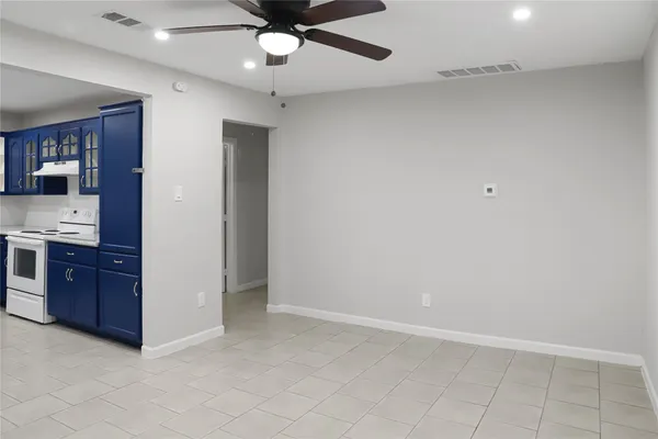 wooden floor in an empty room and a ceiling fan