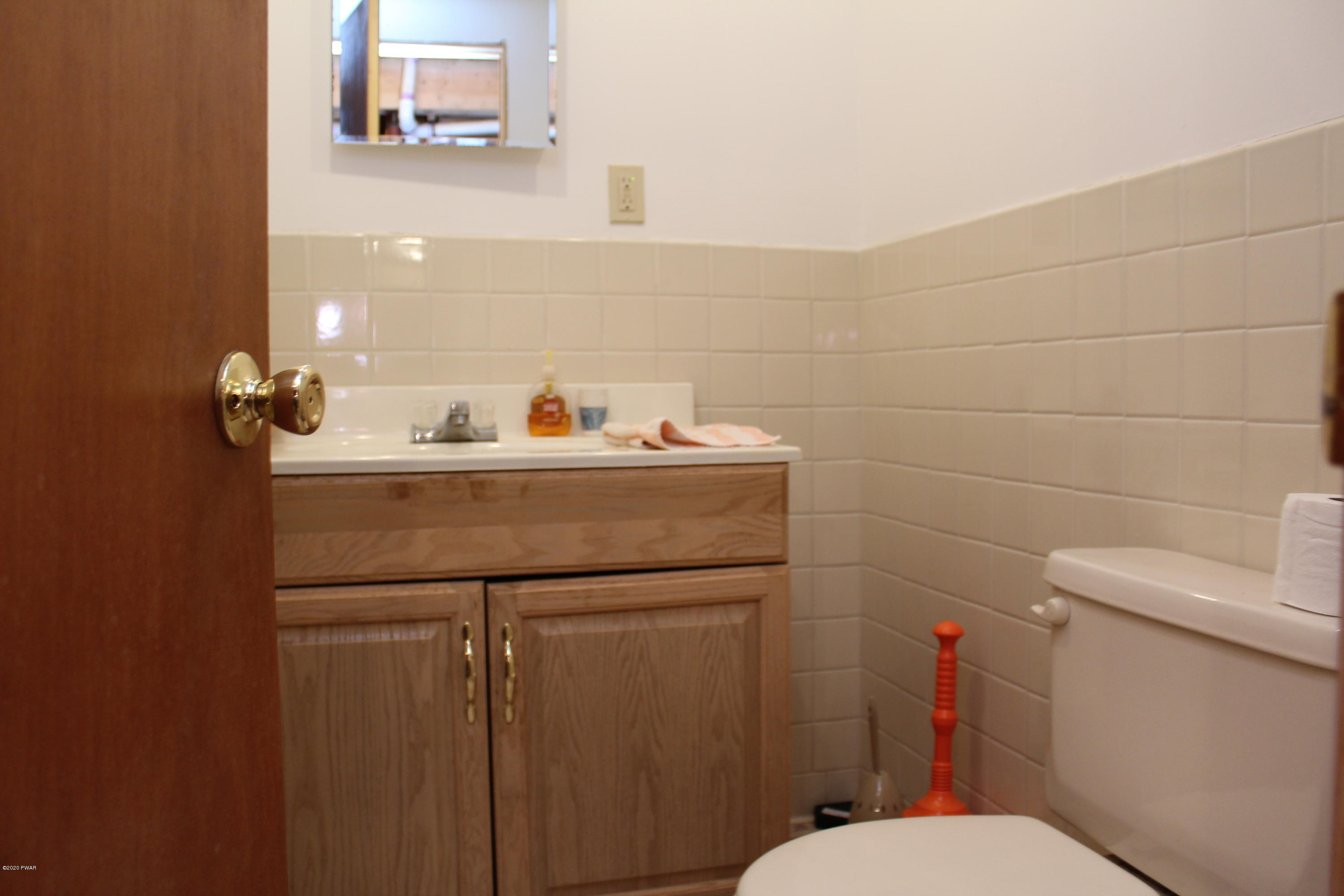382 Northgate Road Lake Ariel, PA 18436 - Photo 19 of 20 a bathroom with a sink a toilet and a mirror