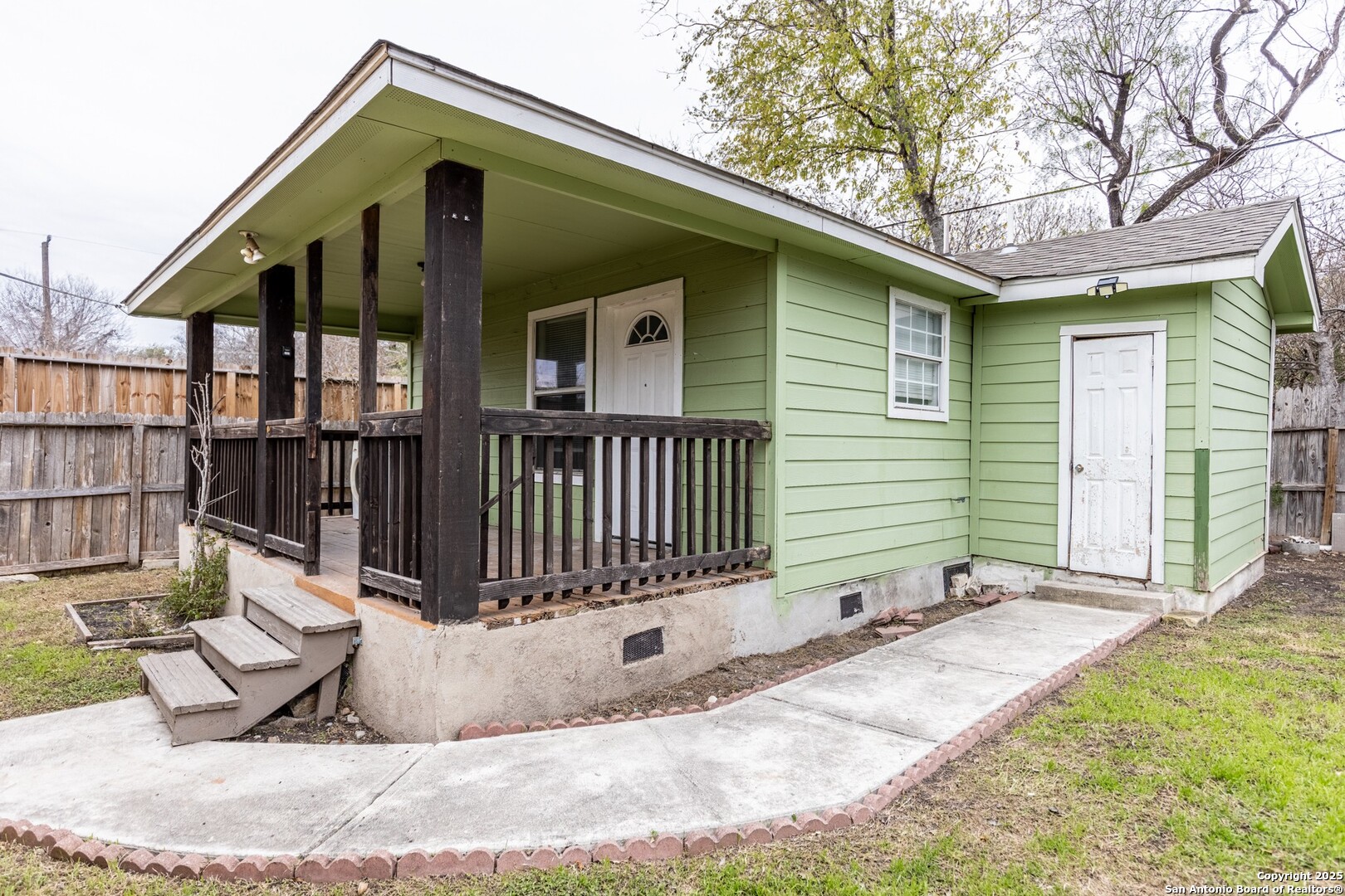 a view of a house with wooden fence and floor