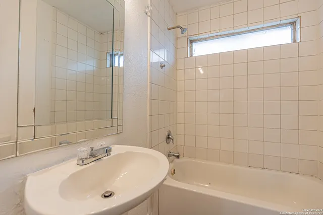 a bathroom with a bathtub and shower